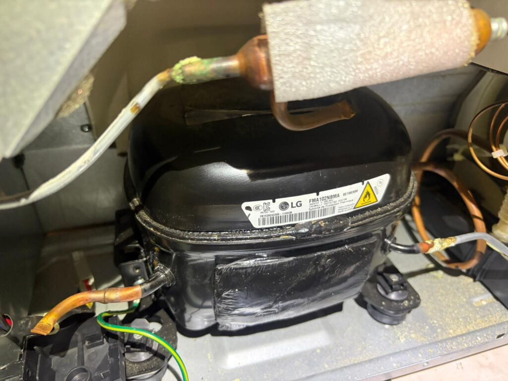LG refrigerator compressor being inspected during refrigerator repair in Brampton