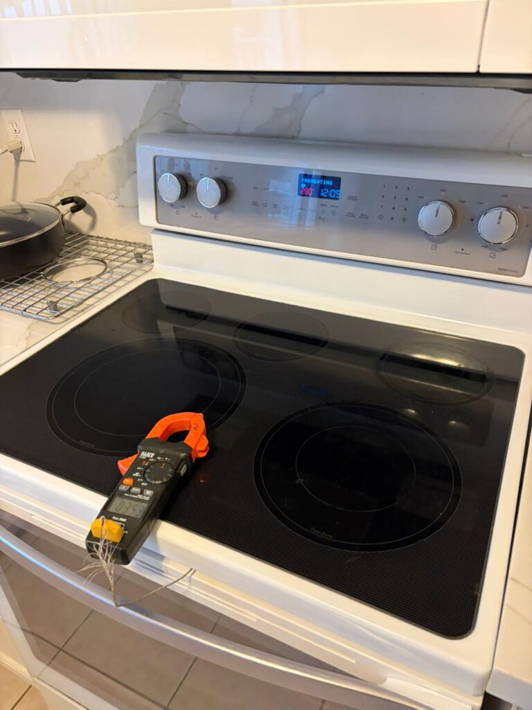 Electric stove and oven undergoing electrical testing during appliance repair in Brampton