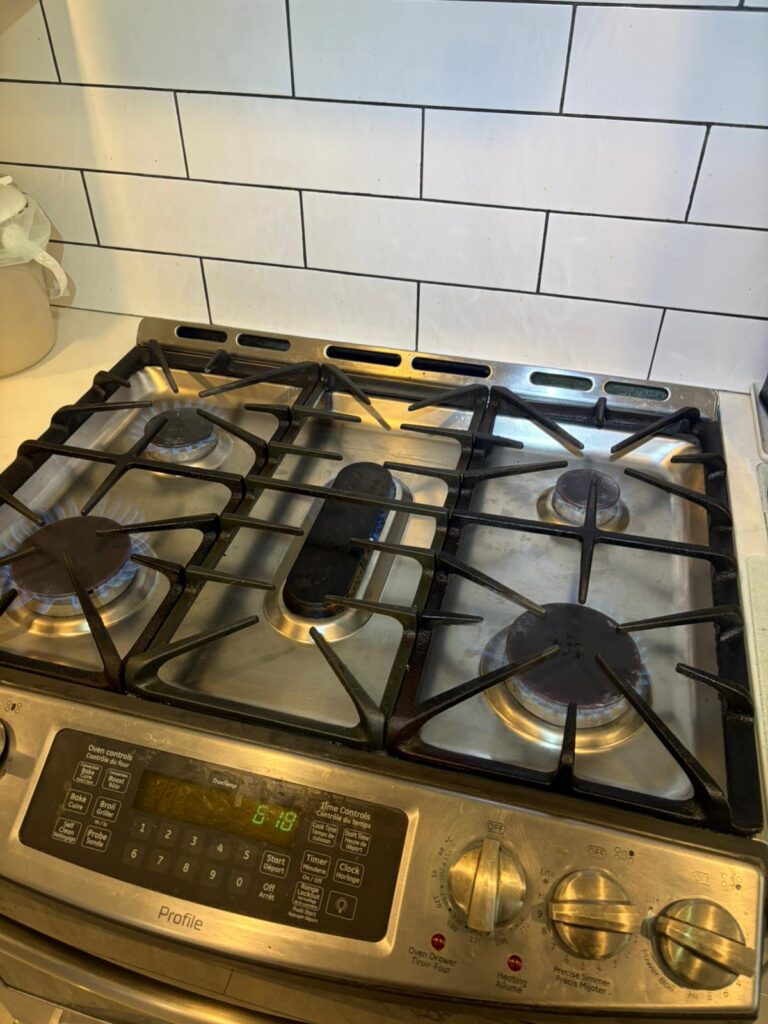 Gas range and oven being inspected for appliance repair
