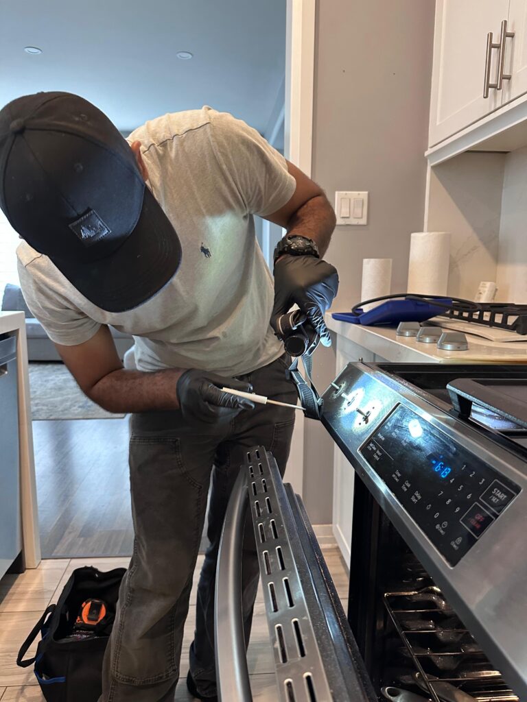 Technician performing same-day electric oven repair in Brampton